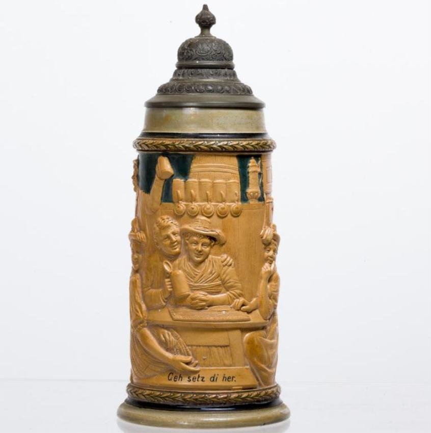 1 LITER STEIN STAMPED GERMANY "CEH SETZ DI HER": Bands of pine sprigs frame a Tyrolean tavern scene in low relief. Pewter lid. Height 11 inches