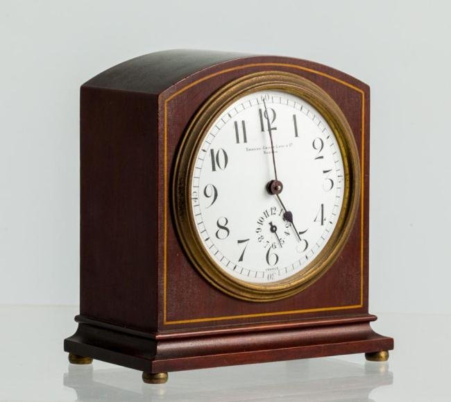 19th c. MANTLE CLOCK WITH FRENCH MOVEMENT: Arched mahogany mantel clock with string inlay and brass bun feet. Couaillet Freres chiming movement with dial signed "Shreve, Crump, Low & Co. Boston. Height 5 1/2 inches