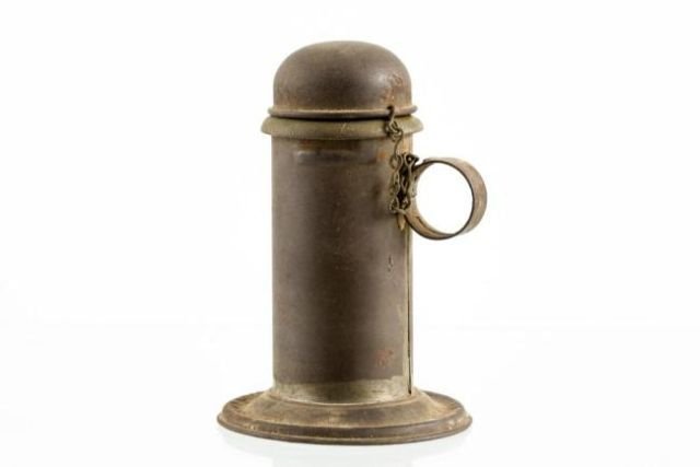 TIN FINGER LAMP (PERHAPS LARD BURNING): Tin font, handle, base and cover. A brass collar and interior spring feeds a solid fluid. Height 5 inches