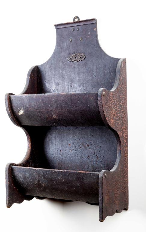 DOUBLE WALL POCKET IN BLACK PAINT: (2) Bowed front pockets connected by conforming swooped ends with bracket bases. Center white metal aesthetic applique. May stand or be hung. 21 x 12 1/2 inches