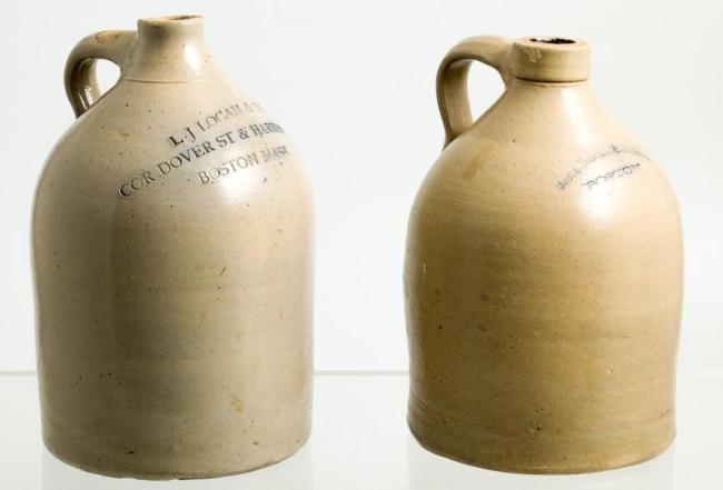 (2) STONEWARE JUGS "JONES" AND "LOGAN" BOSTON: Stamped ""Jones, McDuffee & Stratton, Boston"" and ""L.J. Logan & Co. Cor Dover St. & Harrison Ave Boston Mass"" highlighted in cobalt. 12 inches and under