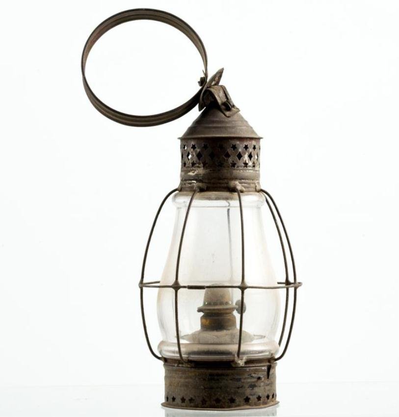 BLOWN MOLDED GLOBE AND TIN STAR-PIERCED LANTERN: Tin lantern with pierced star and diamonds, caged globe and hoop handle. Height 15 1/2 inches