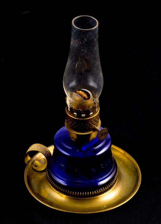 MINIATURE "LITTLE DUTCHESS" FINGER LAMP: Blown molded cobalt lamp embossed with ring of stars and "LITTLE DUTCHESS". Lamp set into spring on brass plate with finger ring for portability. Height 7 inches (at top of chimney)