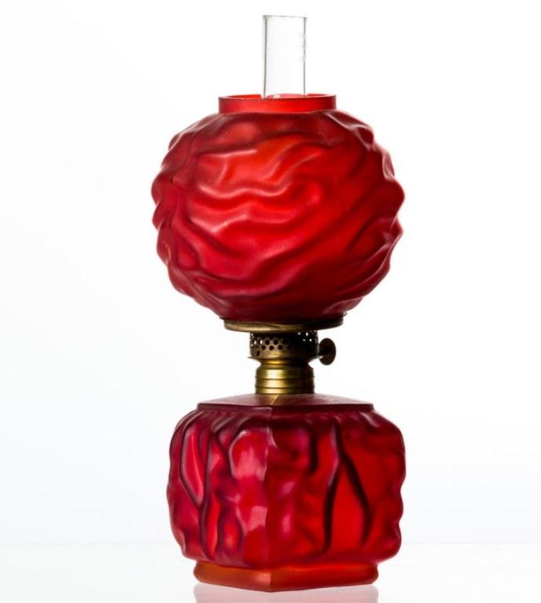 MINIATURE RED SATIN GLASS LAMP: Embossed with ""Drape"" design. P & A Manufacture Co. burner. Height 8 1/4 inches