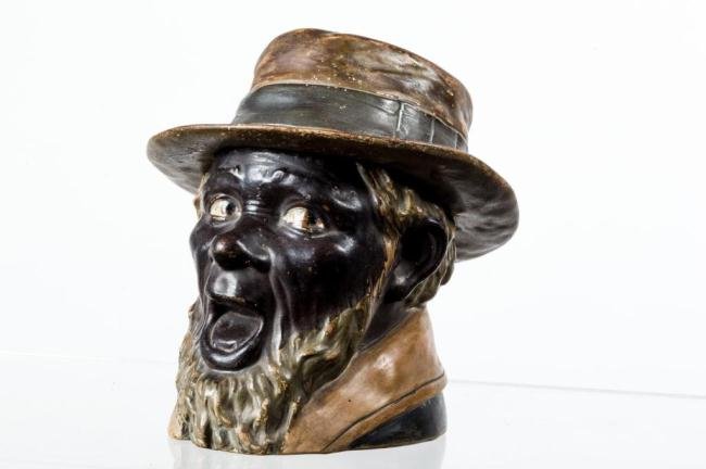 BLACK AMERICANA TABACCO JAR OF A SURPRISED MAN: Hand painted ceramic figural jar with removable fedora cover. Inscribed "BB and 8051" under base. Possibly manufactured by Maresch. Height 6 1/2