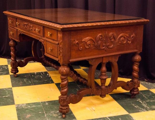 ELABORATELY CARVED OAK PARTNER'S DESK: Acanthus-leaf molded top with carved and molded drawers, 31 x 54 x 36 inches.