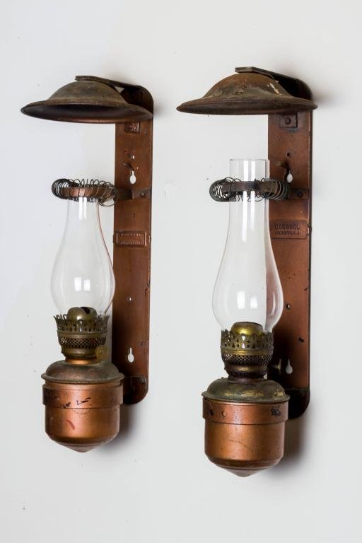 PAIR OF DRESSEL KEROSENE WALL SCONCES FOR RAILROAD CAR: Fitted with exterior wall mount embossed "Dressel Arlington, VA" , smoker and spring chimney support. Copper paint over black. Height 22 inches
