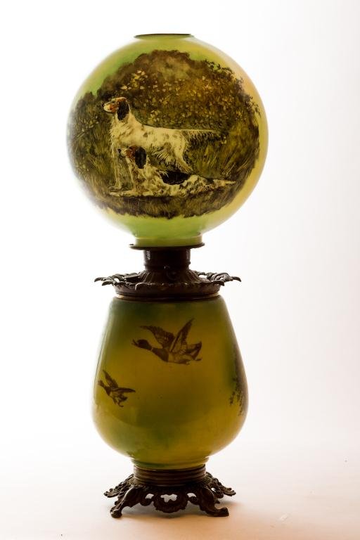 OUTSTANDING GONE WITH THE WIND PARLOR LAMP: Bird dogs on point decorate white milk glass lamp shade and base with yellow and green ground. Miller drop-in burner and font. Globe 11 inches diameter. Height 27 inches