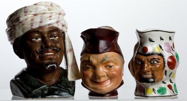 (2) CERAMIC FIGURAL CREAMERS AND A TABACCO JAR: Height 8 in. And under