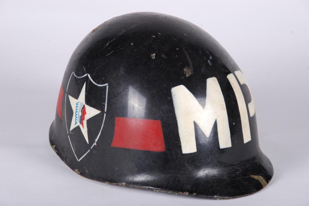 (Mid 20th c.) Military Police Helmut: Paint decorated with Indian in Star within Shield Insignia. Condition: Wear, paint loss