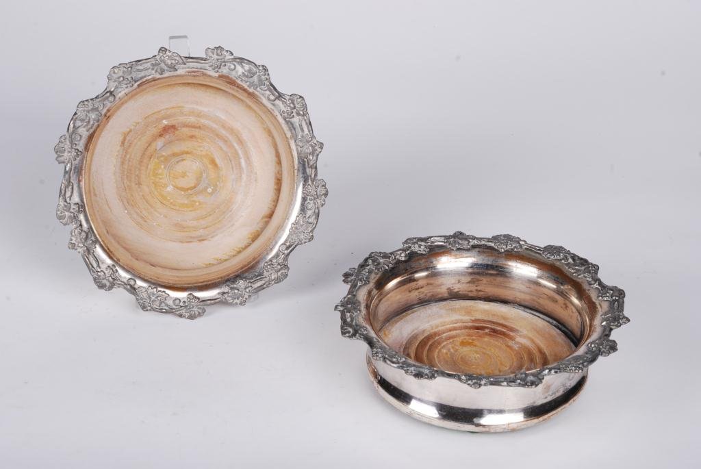 Pair of (19th c.) Sheffield Wine Coasters: Silver plate over copper with hard wood base. 6 3/4 inches in diameter. Condition: Good, minor plating wear