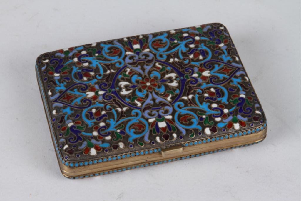 Russian Enamel Antique Cigarette Case Circa 1890: Russian silver and enamel cigarette case of rectangular cushioned form. Periwinkle, cobalt blue, turquoise, white and red enamel, turquoise pellet border. 3 1/4 x 4 1/8 inches. Touch marks present but
