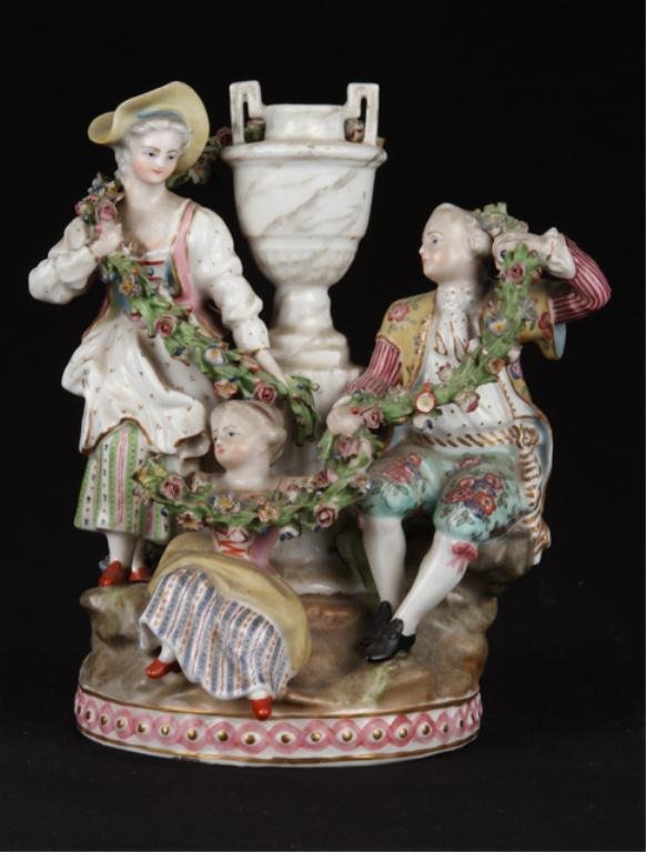 (18th/19th c.) Meissen Porcelain Figural Group: Young family with ropes of laurel with flowers. Height 7 inches. signed. Condition: Young girl missing right arm, rope of laurel from urn to gent absent.