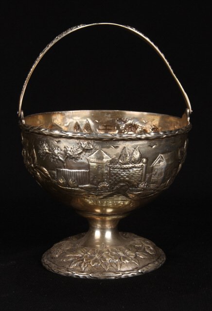 S. Kirk and Son Sterling Silver Swing Handled Bowl: Hand chased with Renaissance Revival and floral motif. Height 6 inches (with handle extended). (approx. 5.5 troy ounces) Condition: Good, handle monogramed and dated 1918.