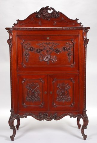 (19thc) Mahogany Music Cabinet Att. Flint & Homer: Rococo carved entablature and paneled sides. Fall front carved with instruments and draping ropes of roses open to sliding shelves, lower cabinet doors carved with harps and horns open to two shelves.