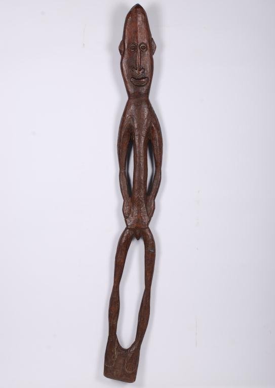 (19th/20th c.) Papua New Guinea Ritual Figure: Carved from a single plank of wood. Length 47 inches. Condition: Good, split to upper leg.