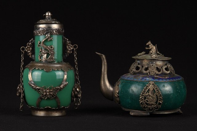 Chinese Tibet Silver Bottle and Tea Pot: Bottle clad with dragon, lion and butterfly motif. Height 4 1/2 inches. Teapot 3 1/4 inches. each signed with a touch mark Condition: Good, teapot missing handle.