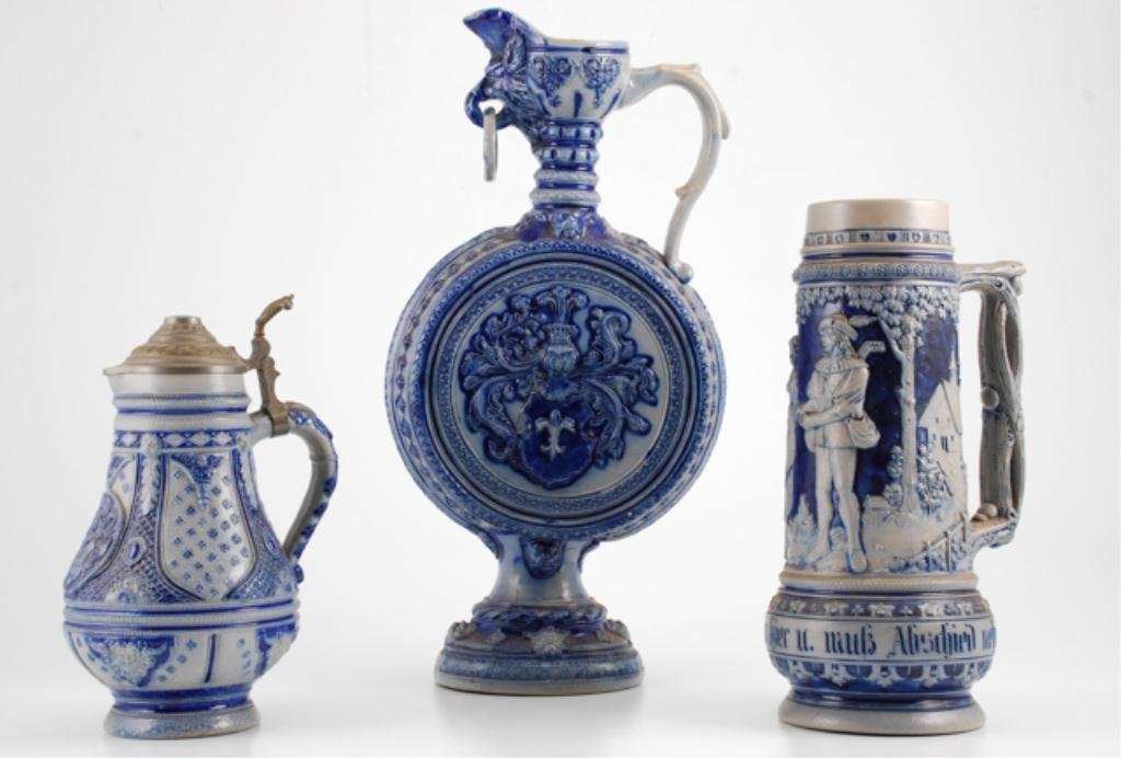 (3) Pieces of German Salt Glazed Stoneware: Including: A ewer form wine pitcher, height 19 1/2 inches, 3 liter stein, height 14 inches and a pitcher with lid, height 12 inches. Condition: Good, minor nicks to glaze surface of ewer.
