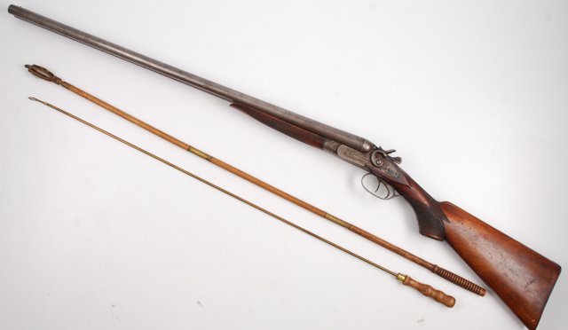 T. Barker Double Barrel Percussion Cap Shot Gun: Elaborately engraved T. Barker double barrel exposed hammer shotgun 12gauge, 30 ¼” barrels, 47” overall. The gun remains in good original condition. T. Barker was a brand name and these arms were