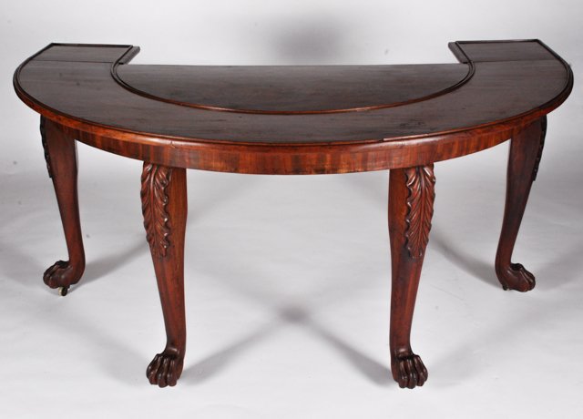 (19th c.) NY Demi Lune Table with Center Insert: Mahogany Butler's Serving table with molded top and (2) conforming drop leaf ends, demi lune center lifts out. Legs carved with acanthus leaves and lion paw feet. Condition: Good