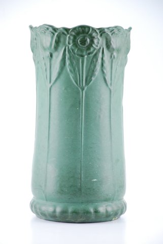 Arts and Crafts Umbrella Stand with Floral Motif: Green glazed ceramic stank with long vertical floral relief motif. unmarked. height 20 inches. Condition: Adhered with splash and specks of white paint