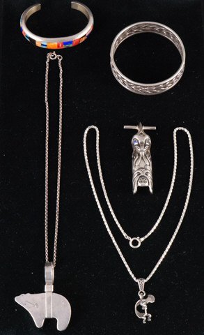 Frank Yellowhorse Bracelet w/ Other Jewelry: Inlaid signed Frank Yellowhorse sterling bracelet, a Nakai sterling bear pendant, a signed "AMI" sterling North Western Native totem pendant with two chains and a pendant Condition: Good Size: 124.8 d