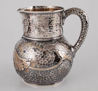 Tiffany & Co. Sterling Silver Water Pitcher: Circa 1877 hand hammered with applied water lilies in the Japanesque style. height 7 1/2 inches. Marked "Tiffany & Co. 3387 Sterling M 1695. 4 1/2 pints". approximately 27.8 troy ounces. Condition: Go