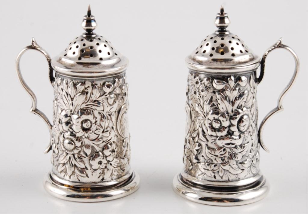 Pair of Flagon Form Sterling Silver Shakers: Hand chased with floral motifs, marked 925, height 3 1/2 inches (each). approximately 4 troy ounces. Condition: Good, monogrammed