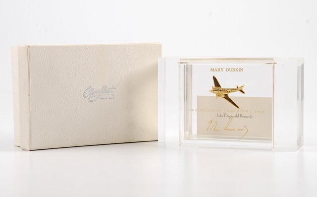 John F. Kennedy "Caroline" Personalized Desk Box: Acrylic box with a model of J.F.K.'s Presidential campaign airplane "Caroline" encapsulated into the lid inscribed "Mary Durkin--Presidential Campaign-1960 John F. Kennedy" in its original "Clearfloat