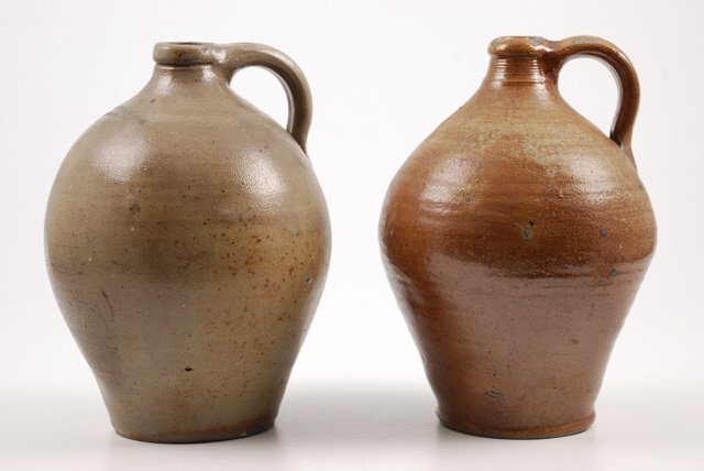 (2) Ovoid Salt Glazed Stoneware Jugs: (1) Orcutt & Crafts Portland Maine. height 11 inches. crack and chips (1) Unmarked. height 11 inches. Rim/ handle chips