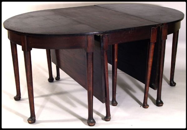 English Queen Anne mahogany three part dining tabl: English Queen Anne bench made mahogany three part dining table. The rectangular center section with drop leaves and D-ends, each raised on circular tapered legs ending in pad feet. Height 29 1/4", Len