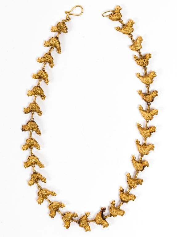 Gold Granulated Bird Necklace Patti Cadby Birch: 18k gold necklace comprised of 28 birds ornately decorated with granulation measures 15 inches and weighs approx. 33.5 dwt. It was sold to the consigner by Patti Cadby Birch (collected Islamic art and