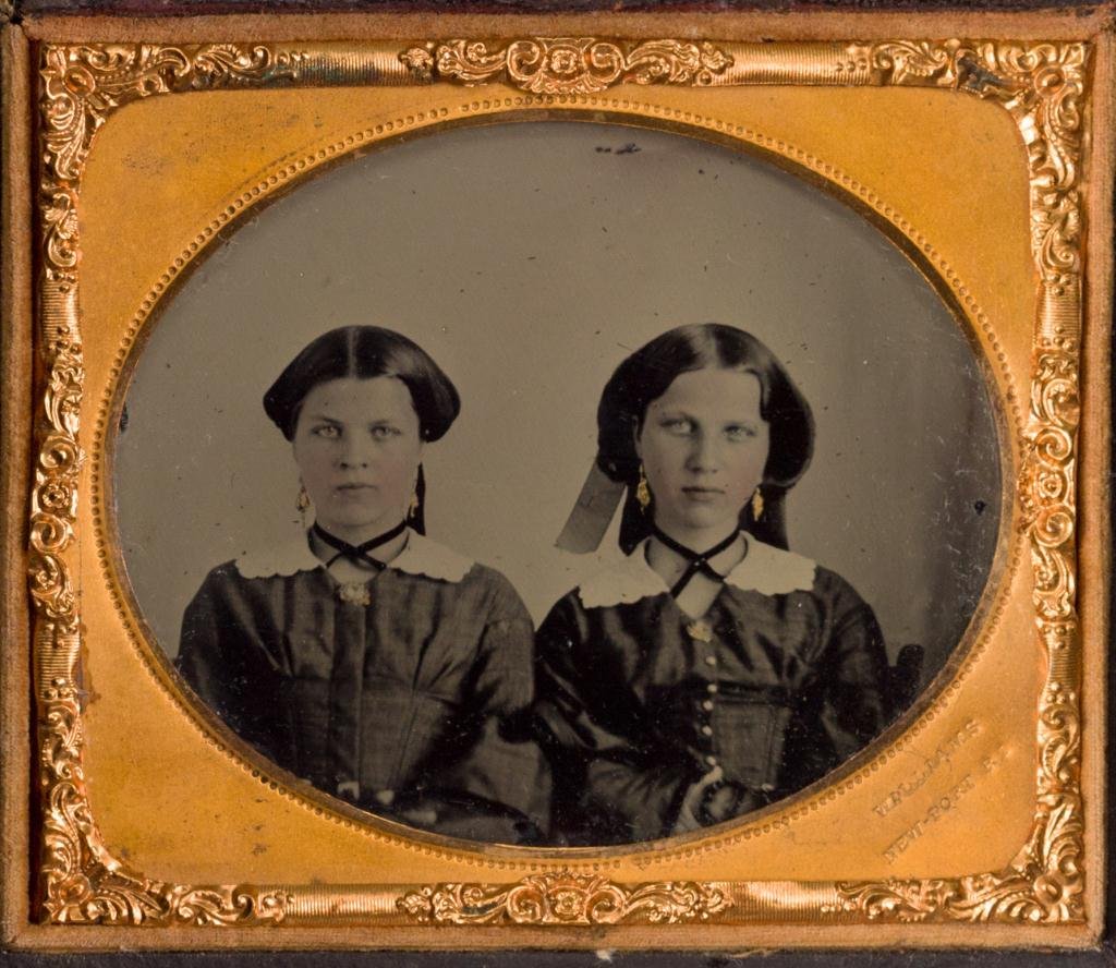 1/6 Plate Ambrotype of Sisters by Williams: Sisters unidentified. Tinted cheeks, mat stamped Williams, (Joshua Appleby Williams) Newport, RI.
