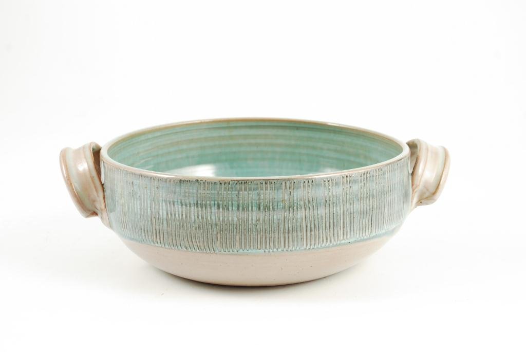 ED AND MARY SCHEIER REDWARE CASSEROLE DISH: Milky and green glazed. Unusual incised ribbed bowl with applied strap handles. 3 3/8 x 11 1/4 (largest dimensions)