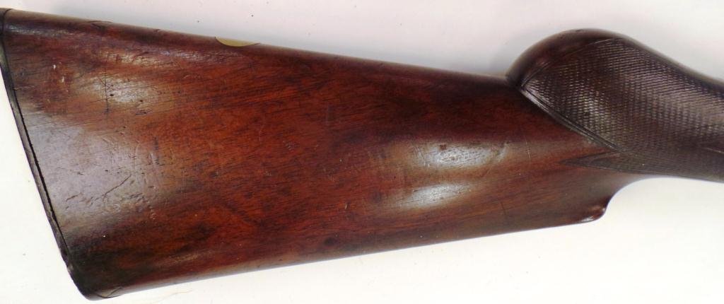 F. WILLIAMS DOUBLE BARREL SHOT GUN: Laminated steel, 44-3/4 inches long, barrel 28 inches and is engraved its entire length. Butt plate is embossed with deer.