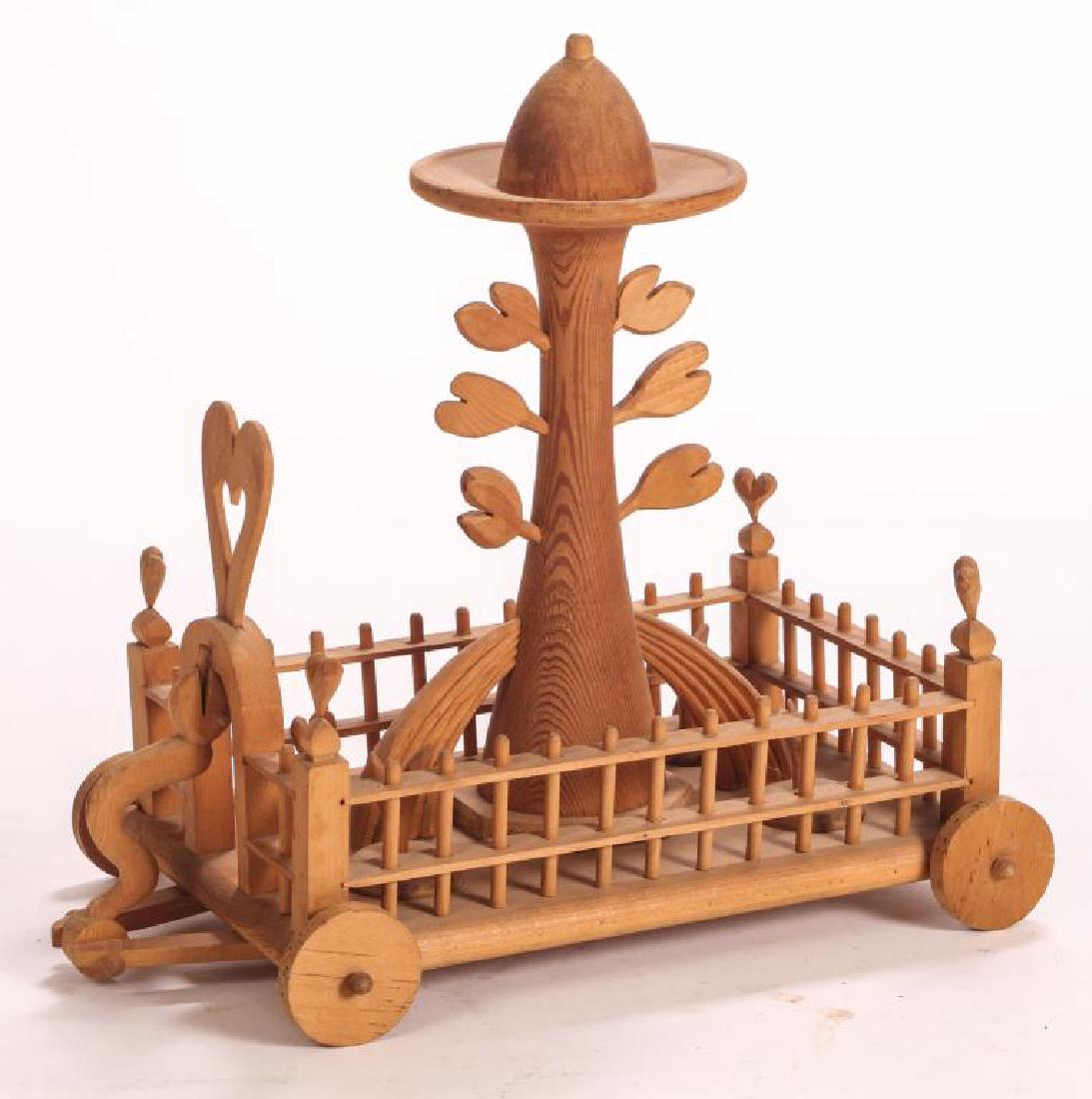 TOMMY SIMPSON (b. 1939): "Garden of Eden" carved pine pull cart. 16 x 16 x 10 inches. signed.