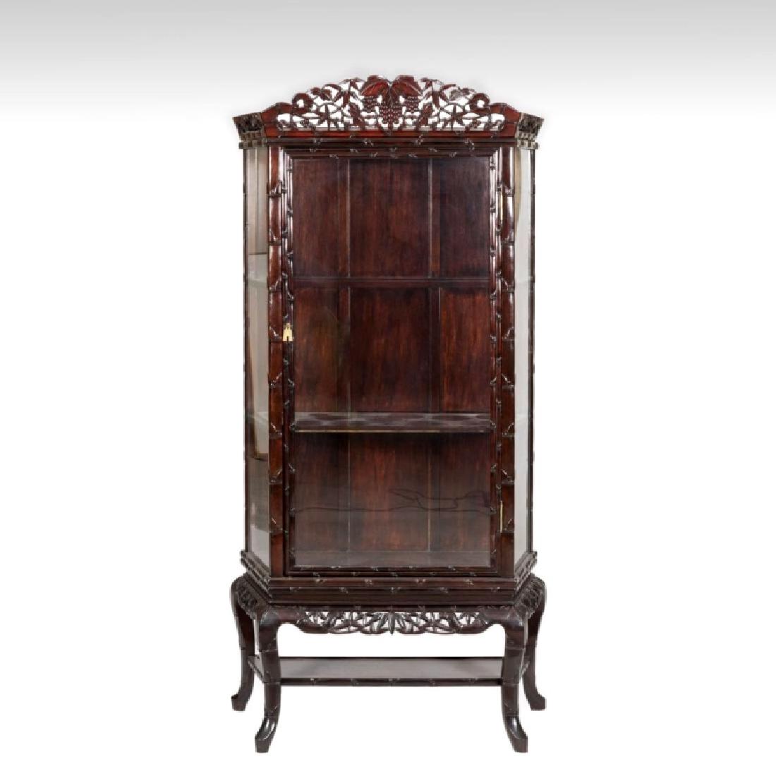 Chinese Carved Hardwood Glass Fronted Cabinet: Chinese Carved Hardwood Glass-Fronted Cabinet in a design of bamboo, the front glass forming a door with two side panels of glass and with a separate and matching 4 legged base. Good condition. Total 