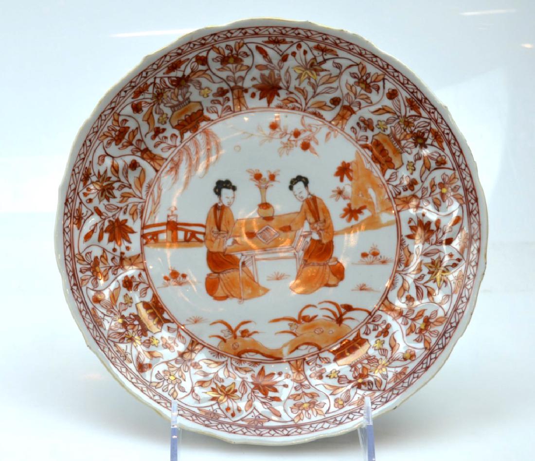 Kangxi Ca 1700 Chinese Porcelain Plate; Iron Red: Kangxi Ca 1700 molded Chinese Porcelain Plate; well decorated in Iron Red and gold with figures playing a game. Good condition, a very few small glaze flakes to edge and foot. Diameter 8 3/4 inches (2