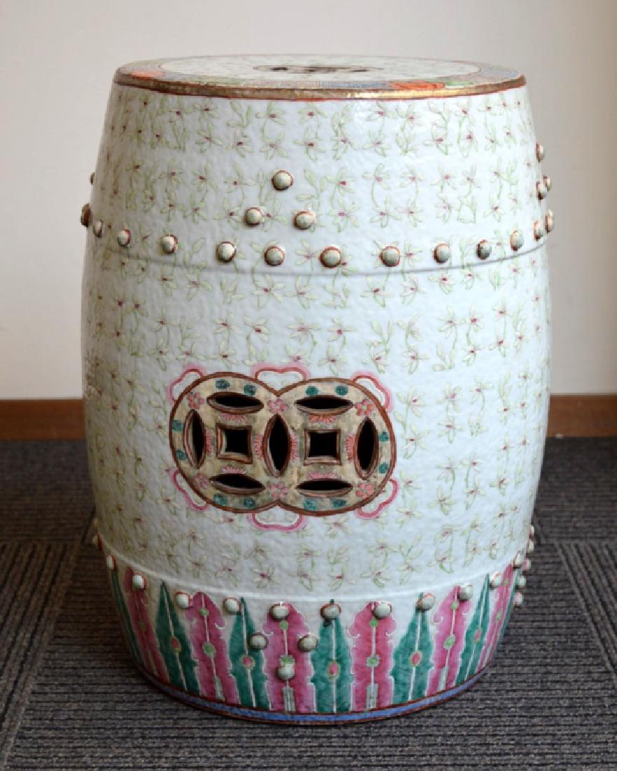 119th C Chinese Orchid Porcelain Garden Seat: 19th C Chinese Porcelain Garden Seat covered in Famille Rose Enamels with raised enamel white orchids and with a design around the base of multicolored Phoenix Feathers. Two little bosses missing arou