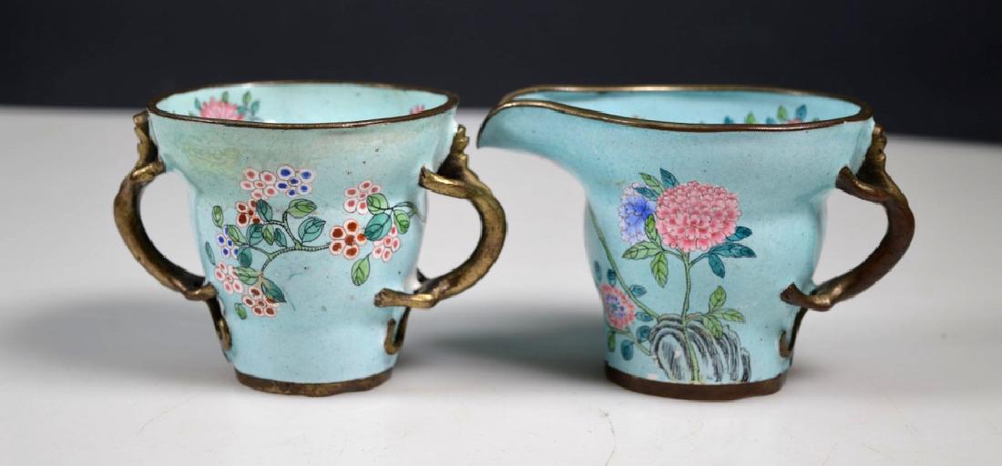 Late Qing Chinese Canton Enamel Sugar & Creamer: Late Qing Chinese Canton Enamel Sugar & Creamer each with bronze Dragon handles, the surface with a pale blue background color. The sugar with a few hairlines and some old overpainting. Length of crea