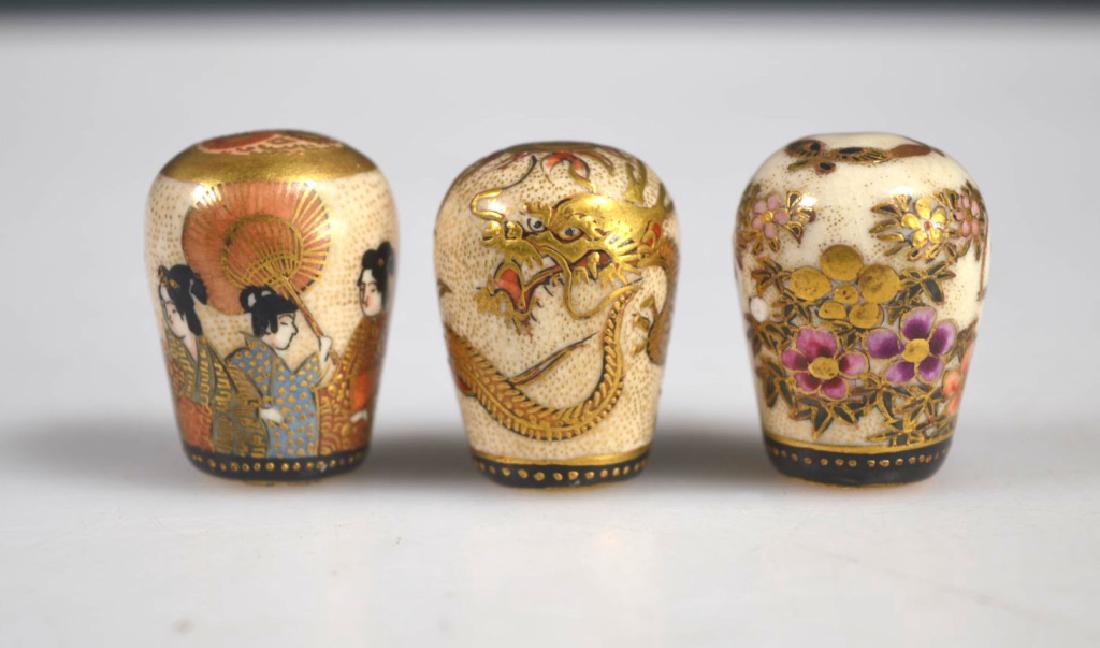 Three Fine Japanese Decorated Satsuma Finials: Three Fine Japanese Decorated Satsuma Finials: a white parrot on a swing among blossoms; a 3-Claw Dragon; seven Geisha, one with umbrella. Light wear to raised gold. Approximate height of each 1 inch 