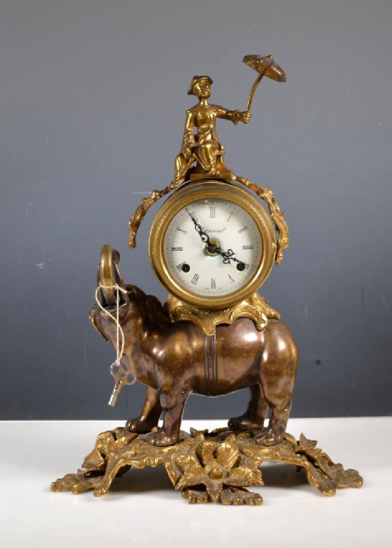 Cast Metal Elephant Chiming Clock: Cast Metal Elephant Chiming Clock, the top with a seated Chinaman and an umbrella; the face printed "Imperial" and "Made in Italy", the reverse of the movement says "Germany". Light age related wear t