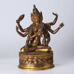 Tibetan Gilt Bronze Guanyin, open Lotus Throne: Tibetan Gilt Bronze Guanyin with multiple hands and faces, seated on an open Lotus Throne. Age related wear to gold and bronze. Weight 4,706 grams. Height 11 in ches (28 cm.).