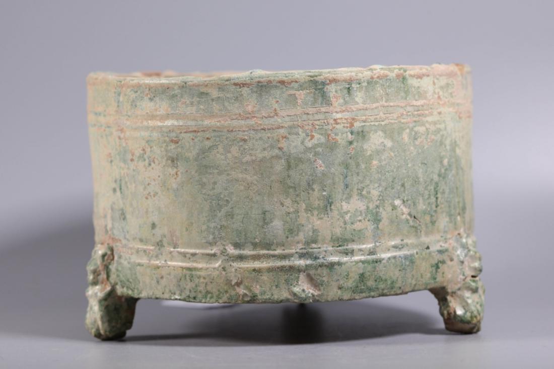 Chinese Han Dynasty Green Glazed Censer: Chinese Han Dynasty Green Glazed Censer, on three animal feet and the surface with 4 engraved lines, the green glaze now iridescent. Age related wear. Height 5 3/8 inches (13.6 cm.). Diameter 8 1/4 in