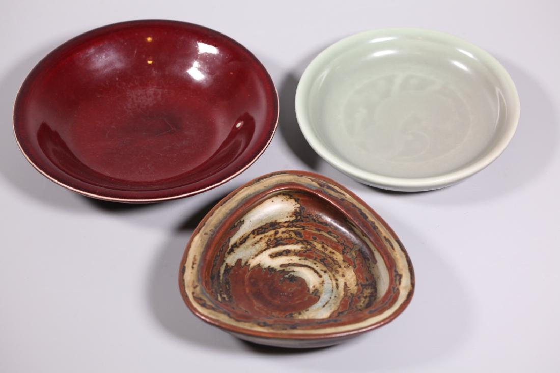 Three Royal Copenhagen Ceramic Bowls 1920's-30's: Three Royal Copenhagen Ceramic Bowls 1920's-30's; 1. a Carl Halier Oxblood Glazed Bowl with green RC Denmark Mark, 2. a fine celadon plate with impressed animal to center and undeciphered mark (FG?) t