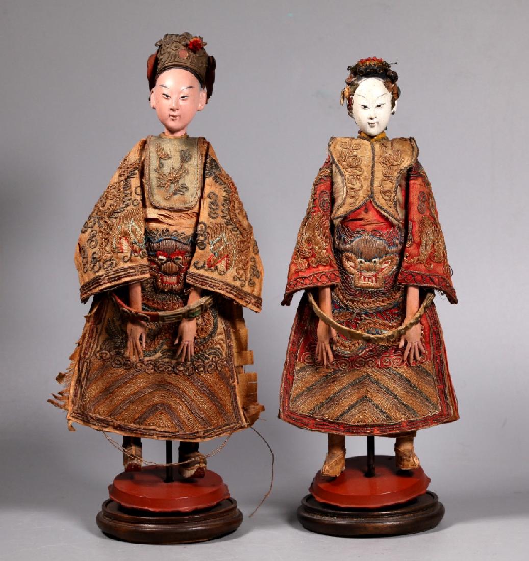 Chinese 19 C Emperor & Empress Toy Dolls: Chinese 19 Century Emperor & Empress Toy Dolls with finely detailed heads and hands, dressed in silk clothing embroidered with forward facing Dragons in couched gold wrapped threads, the sleves with p