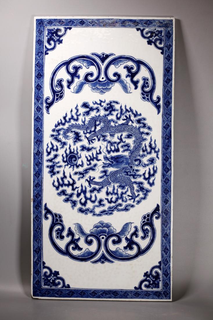 Lg Chinese Blue & White Dragon Porcelain Plaque: Large Chinese Blue & White 4-Claw Dragon & Flaming Pearl Porcelain Plaque with scrolling flowers and a wan trellis border. Good condition with light age related wear, 2 small glaze flakes to edge, 1 c