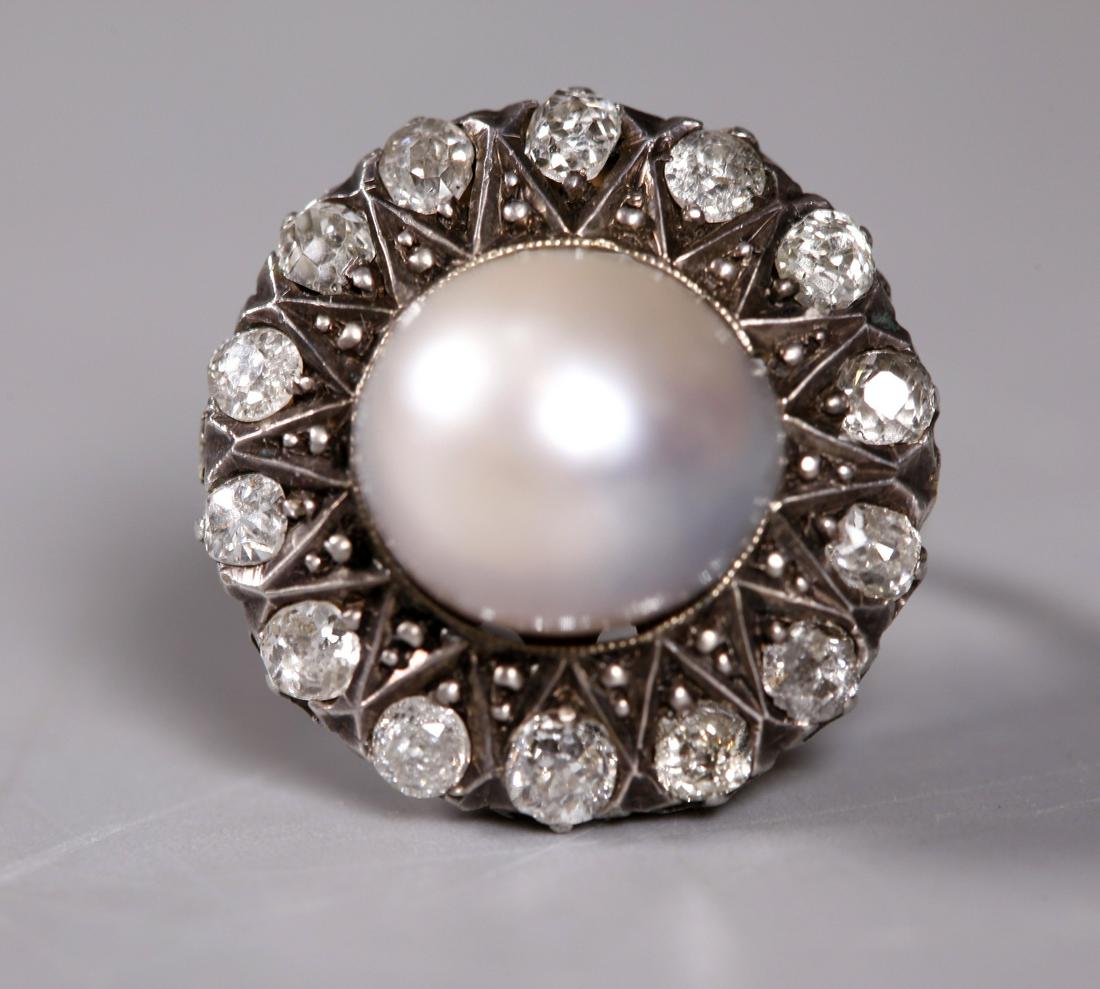 Victorian Baroque Pearl Old Mine Diamonds 18K Ring: Victorian Baroque Pearl set with 14 Old Mine Diamonds in a white and yellow gold 18K Starburst Ring. US ring size 6 3/4. Total weight 6.8 grams. Age related wear to stones, pearl, and gold. __________