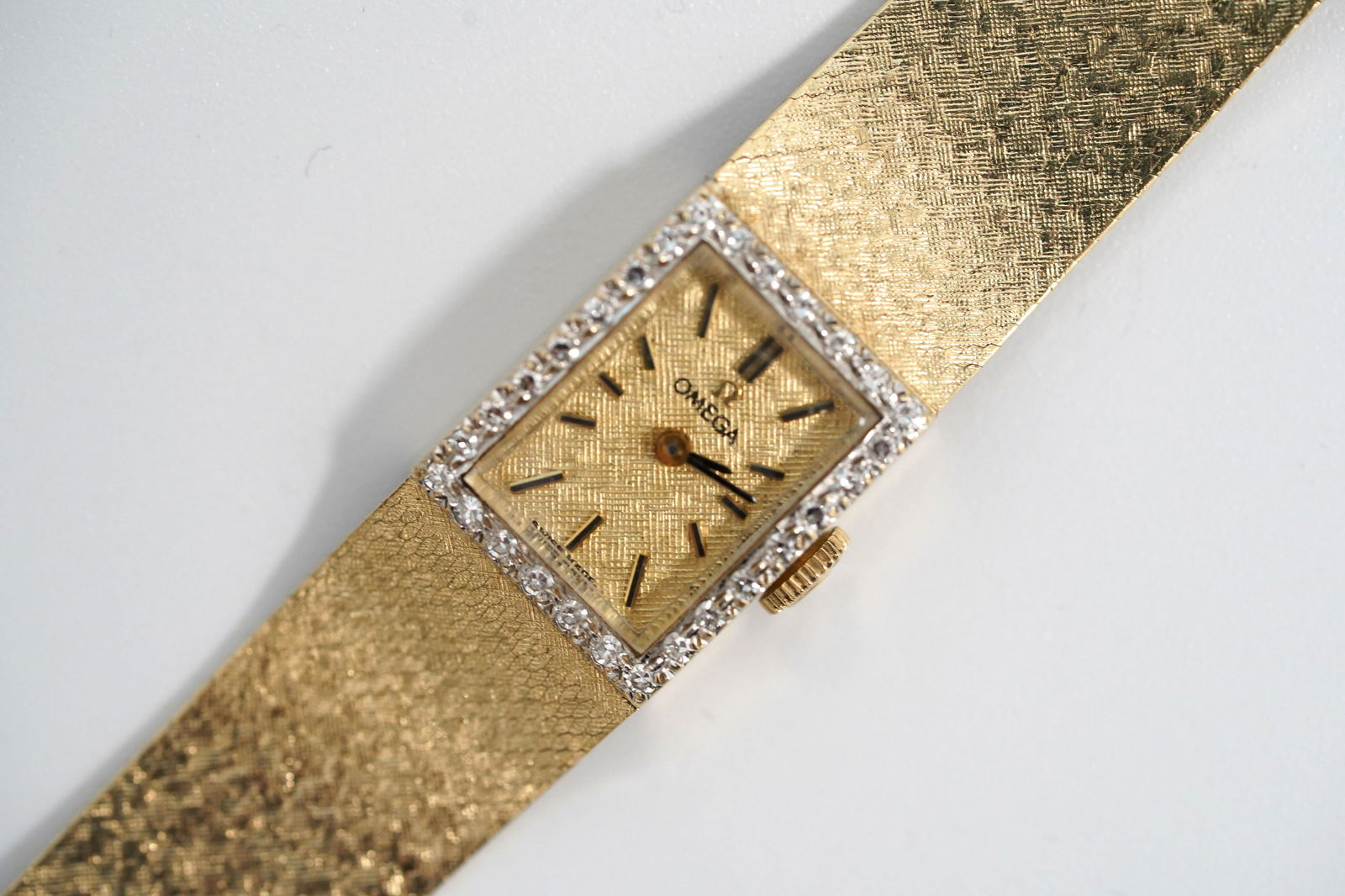 Vintage Omega 14K & Diamond Lady: Vintage Omega 14K yellow gold & Diamond Lady's Wristwatch, the closure with Omega Logo. This watch is in working condition. Total weight 30.8 grams. Length 6 3/4 inches (17 cm.). Light age related wea