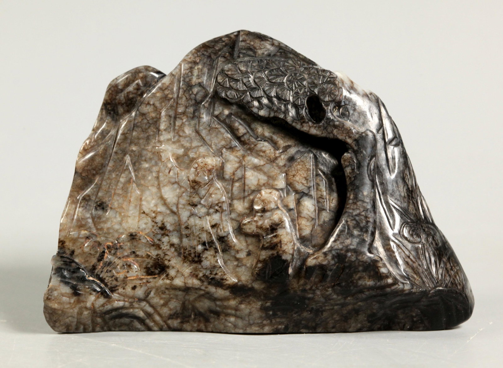 Chinese Ming Dynasty Chicken Bone Jade Mountain: Chinese Ming Dynasty Chicken Bone Jade Mountain carved with a Scholar inscribing a Rock and a Scholar watching a waterfall, both with pine trees. Height 2 7/8 inches (7.3 cm.) X width 4 1/4inches (10.